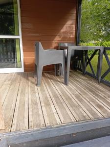 a chair and a table on a porch at Bungalow tonga in Moncetz-lʼAbbaye +4 photos