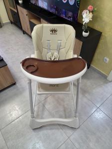 a high chair with a crown on top of it at Golden Time SM Apartman in Sremska Mitrovica