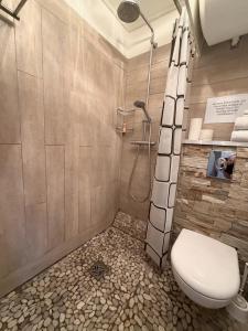 a bathroom with a toilet and a shower at Studio cosy climatisé vue sur port in Cap d'Agde