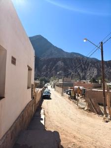 a car parked on a dirt road next to a building at ElPoro in Purmamarca