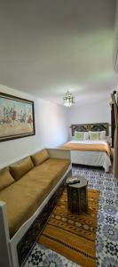 a living room with a couch and two beds at Dar Mounia Les Oudayas in Rabat