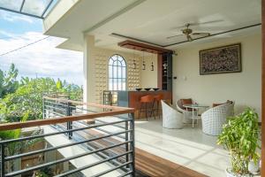 a balcony of a house with a table and chairs at D'nala Villa - 4 bedroom villa in Lebih
