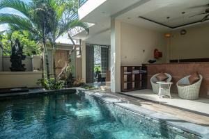 a swimming pool in the middle of a house at D'nala Villa - 4 bedroom villa in Lebih