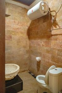 a bathroom with a toilet and a sink at D'nala Villa - 4 bedroom villa in Lebih +25 photos