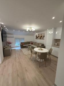 a living room with a couch and a table at Meddy Luxury Apartment in Mostar