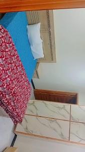 a close up of a bed with marble floors at Dream suits in Lower Topa