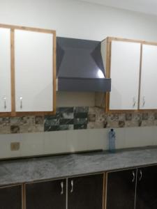 a kitchen with a hood over a kitchen counter at Dream suits in Lower Topa