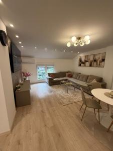 a living room with a couch and a table at Meddy Luxury Apartment in Mostar