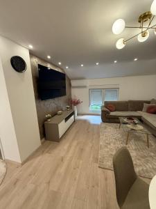a living room with a couch and a tv at Meddy Luxury Apartment in Mostar