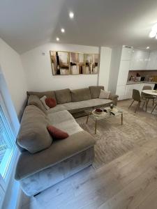 a living room with a couch and a table at Meddy Luxury Apartment in Mostar