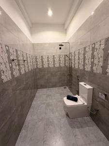 a bathroom with a toilet and a shower at Cozy Bay Hotel in Arugam Bay +85 photos