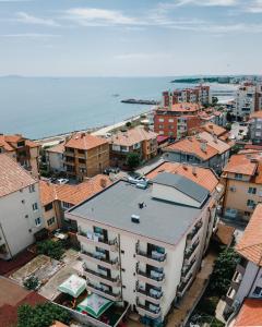 an aerial view of a city with buildings and the ocean at Stamatovi Family Hotel in Pomorie