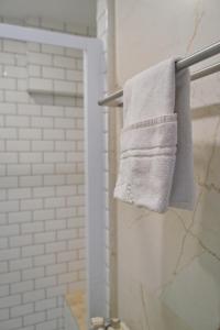 a towel hanging on a towel rack in a bathroom at Margherita in Reims +33 photos