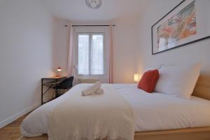 a bedroom with a white bed and a window at Margherita in Reims