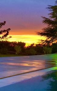 a sunset over a parking lot with trees in the background at Il Sentiero dei Goti San Marino e Montefeltro in Monte Grimano Terme +179 photos