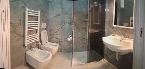 a bathroom with a sink and a toilet and a shower at Hotel Solferino in Brescia +10 photos