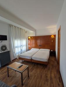 a bedroom with a bed and a coffee table at Hotel Trefacio in Zamora +42 photos