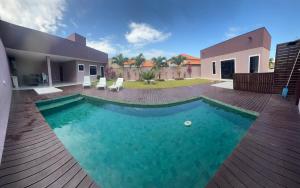 a swimming pool in the backyard of a house at Faith Home 1 in Arraial do Cabo