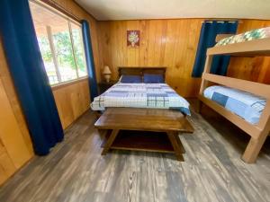 a bedroom with a bunk bed and a table at Shady Oak in Concan