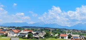 a village with houses and mountains in the background at Mountain view in Medvode