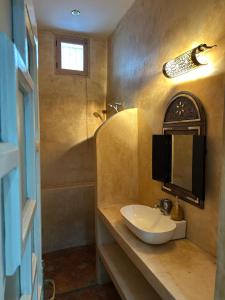 a bathroom with a sink and a mirror and a shower at Riad Dar Lina Logement entier in Rabat +22 photos