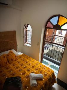 a bedroom with a bed with a towel on it at Riad Dar Lina Logement entier in Rabat