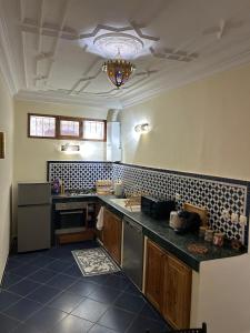 a kitchen with a sink and a counter top at Riad Dar Lina Logement entier in Rabat
