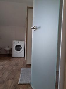 a bathroom with a washing machine and a washer and dryer at Mountain view in Medvode +3 photos