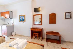 a living room with a table and a kitchen at VILLA Vasilios EXARHOS in Paralia Katerinis