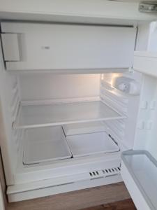 an empty refrigerator with its door open at Mountain view in Medvode