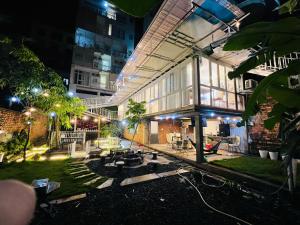 a building with a fire pit in a courtyard at night at Nice Hotel Buôn Ma Thuột in Buon Ma Thuot