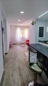 a large living room with a table and a couch at Valencia Room in Cuart de Poblet