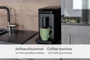 a coffee machine sitting on a counter with a cup at Charme & Moselblick im Alten Winzerhaus am Calmont in Bremm