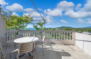 a table and chairs on a balcony with a view at Apartments Bašić Pirovac - Sea view - Small and large groups in Pirovac
