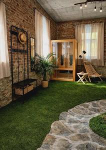 a patio with a grass yard with a bench and a table at Pajtl indoor glamping in Črna na Koroškem
