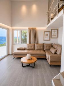 a living room with a couch and a table at Thalasson Beach House in Koroni