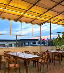 a patio with tables and chairs and a view of the airport at Milliy Hotel - Namangan city in Namangan