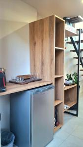 a kitchen with a stainless steel refrigerator and a counter at Dris Loft in Nikiana