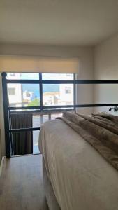 a bedroom with a bed and a large window at Dris Loft in Nikiana +6 photos