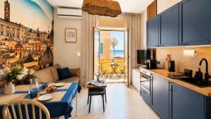 a kitchen and living room with a couch and a table at Oceanine 7 - Seaview Apartment in Lido di Ostia