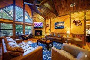 a living room with leather furniture and a fireplace at After the Sunset 1-Level 5BR Pool - Arcade in Broken Bow
