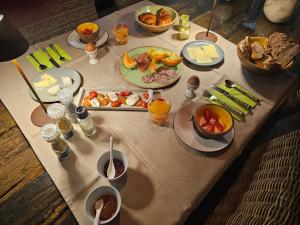 a table with plates of food and drinks on it at Mas À l'Improviste in Saint-Rémy-de-Provence