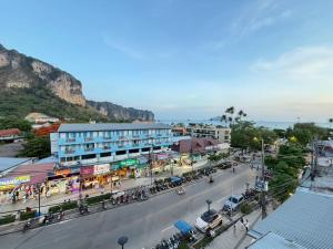 a street in a town with a mountain in the background at J Home in Ao Nang Beach