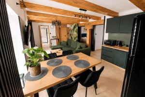 a kitchen and dining room with a table and chairs at Apartament Rynek Szmaragd in Szamotuły