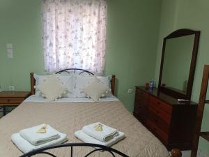 a bedroom with a bed with a mirror and a dresser at Forest Retreat Near the Sea Kouvaras in Kouvarás