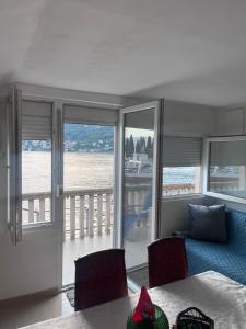 a living room with a couch and a view of the water at Beara in Lepetani