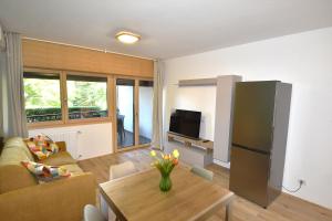 a living room with a table and a refrigerator at La Perla del Lago in Luino