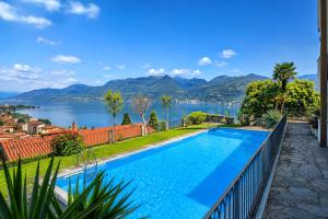 a swimming pool with a view of the water and mountains at La Perla del Lago in Luino