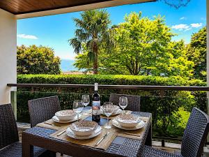 a wooden table with wine glasses on a patio at La Perla del Lago in Luino