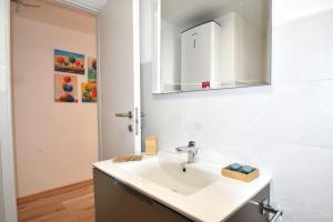 a bathroom with a sink and a mirror at La Perla del Lago in Luino +10 photos